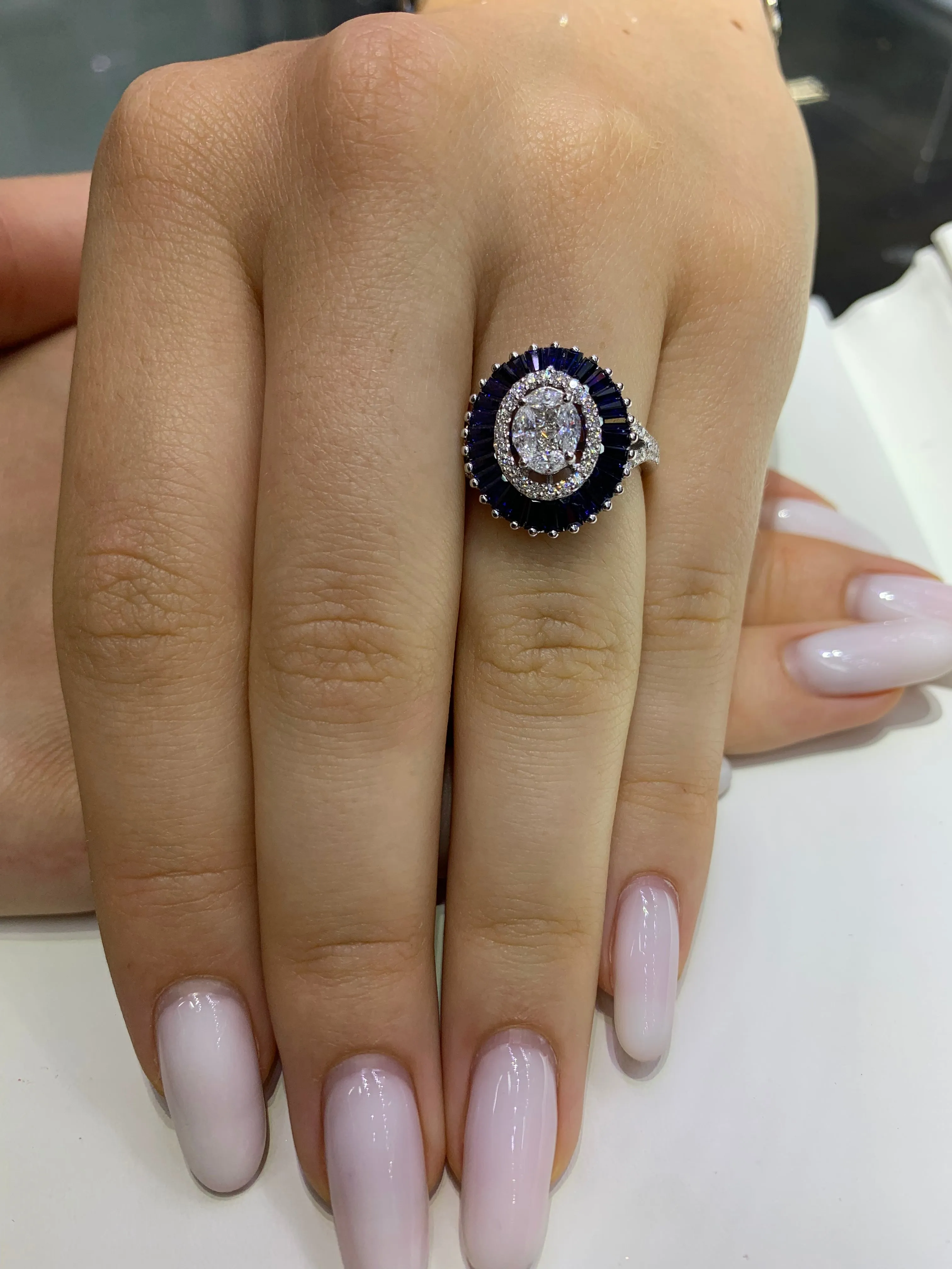 VVS/vs EF color high clarity diamonds set in a 18k Gold Oval Shaped Blue Sapphire Ring with Round Diamonds